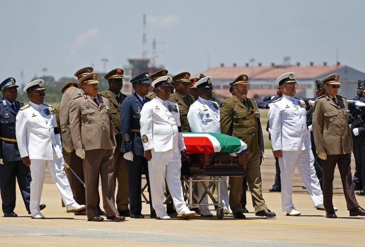 The coffin of former South African President Nelson Mandela is escorted aboard a military cargo plane. (Reuters picture)