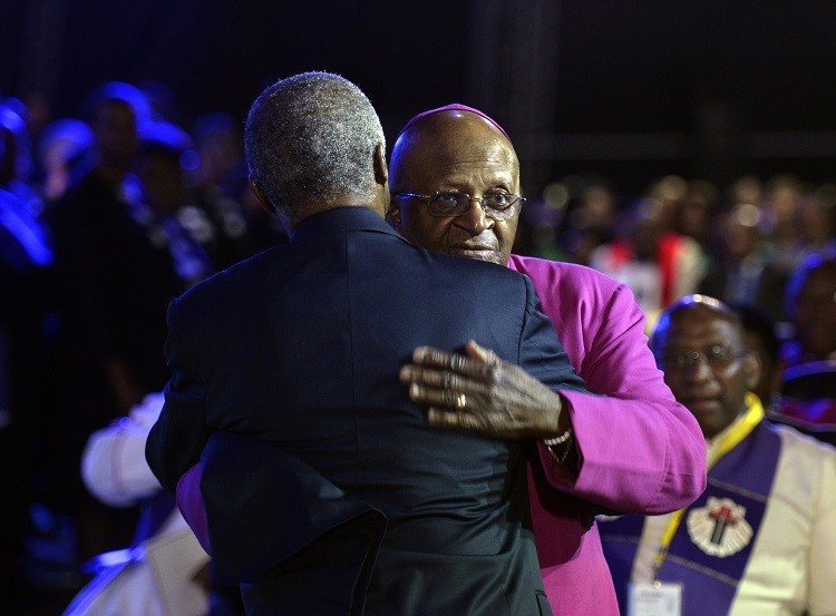 Archbishop Desmond Tutu R and former South African President Thabo Mbeki greet each other before the funeral ceremony of former South African President Nelson Mandela in Qunu December 15, 2013. Reuters picture