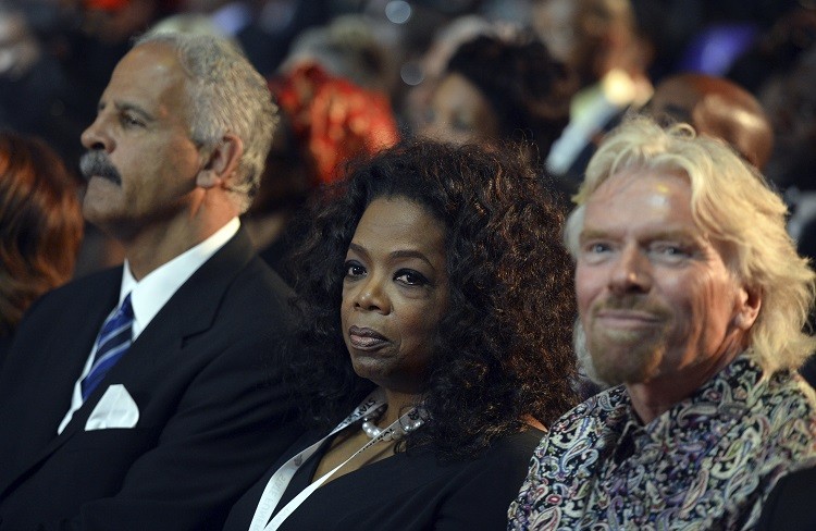 British entrepreneur Richard Branson R and U.S. TV host Oprah Winfrey C attend the funeral ceremony for former South African President Nelson Mandela in Qunu December 15, 2013. Reuters picture