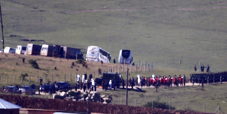 The funeral cortege, carrying the coffin of former South African President Nelson Mandela on a gun carriage, makes its way from his house to a tent where the funeral service will be within the Mandela familys property in the village of Qunu December 15,