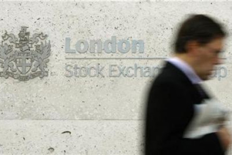 A man walks past the London Stock Exchange in the City of London