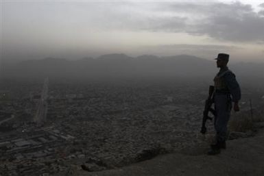 An Afghan soldier stands guard in front of the Afghan Television station in Kabul