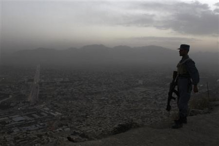 An Afghan soldier stands guard in front of the Afghan Television station in Kabul