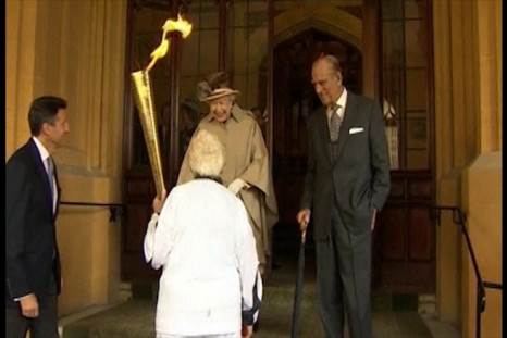 Queen watches Olympic Torch pass Windsor Castle