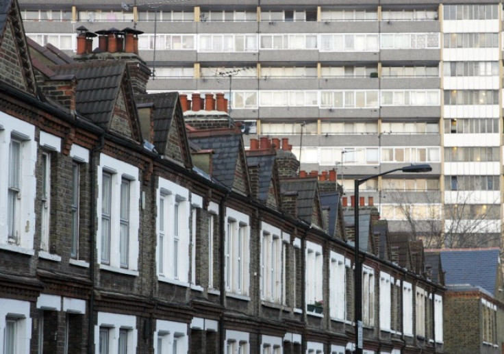 A terraced row of houses is pictured in front of a residential tower block in London