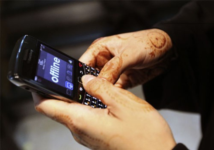 A woman uses her Blackberry mobile device at a shopping mall in Dubai