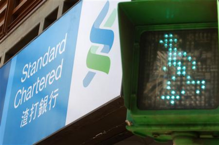 A Standard Chartered logo is seen beside a traffic light at a junction in Taipei