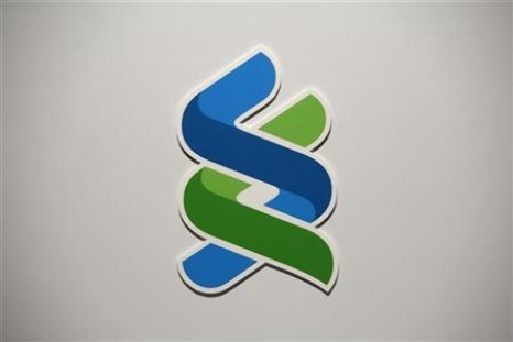 A company logo of Standard Chartered bank is displayed during a news conference in Hong Kong