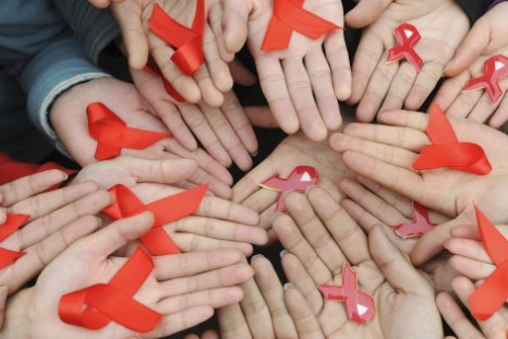 WHO urges focus on HIV patients' human rights on World AIDS Day University students hold red ribbons at a photo opportunity during an HIV/AIDS awareness rally on World AIDS day in Chengdu, Sichuan province more than a year ago on December 1, 2009.