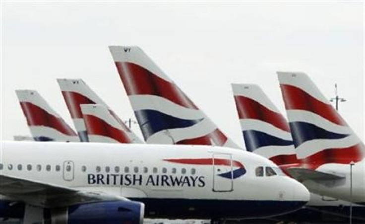 A British Airways passenger jet taxis past parked BA jets at Heathrow airport in London July 30, 2010.