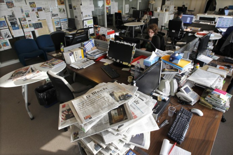 Journalists work in the daily Le Monde newsroom at their offices in Paris