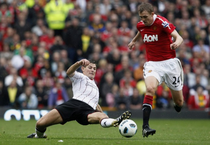 Manchester United's Fletcher is challenged by Liverpool's Gerrard during their English Premier League soccer match at Old Trafford in Manchester. Manchester United's Fletcher is challenged by Liverpool's Gerrard during their English Premier League soccer match at Old Trafford in Manchester.