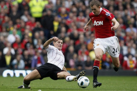 Manchester United's Fletcher is challenged by Liverpool's Gerrard during their English Premier League soccer match at Old Trafford in Manchester.