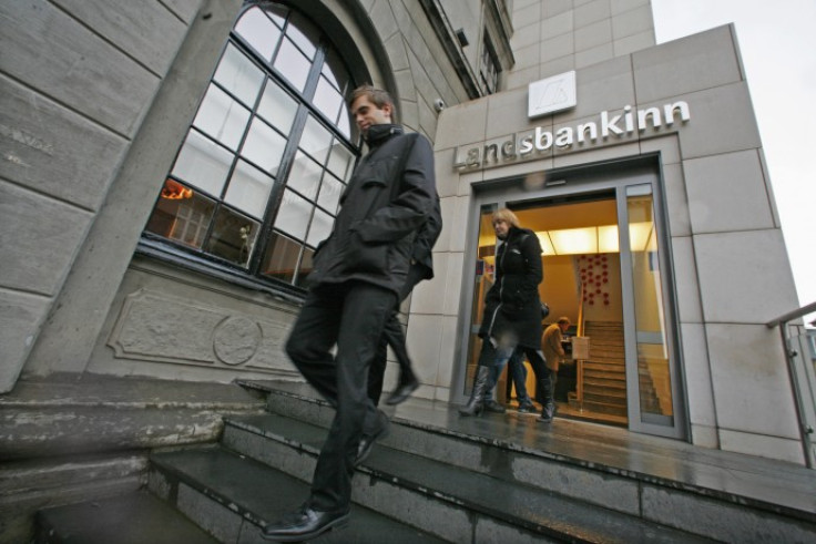 Customers leave the main branch of Landsbankinn Bank in Reykjavik