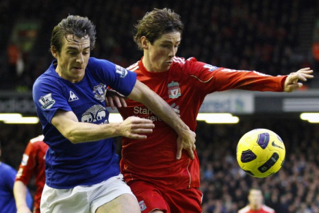 Everton's Baines challenges Liverpool's Torres during their English Premier League soccer match in Liverpool.