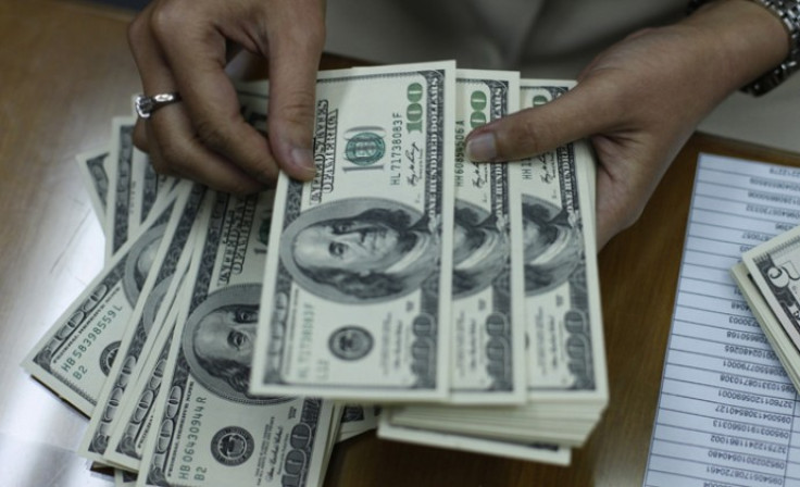 Employee counts U.S. dollar at money changer in Jakarta