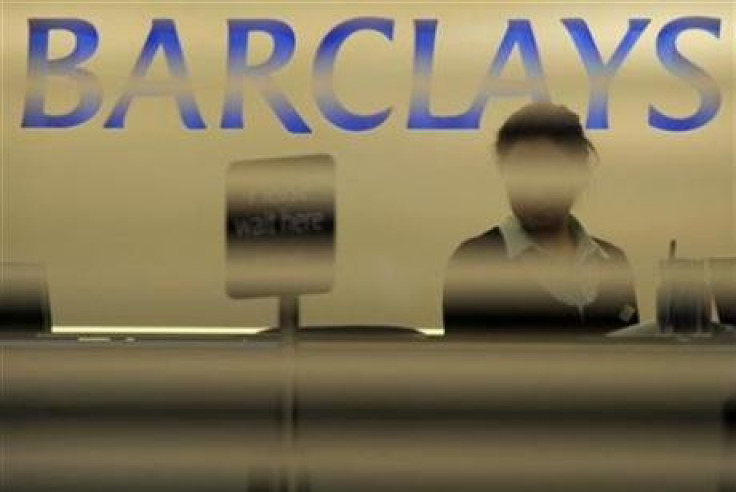 A worker waits for customers in a branch of Barclays bank in London February 16, 2010.