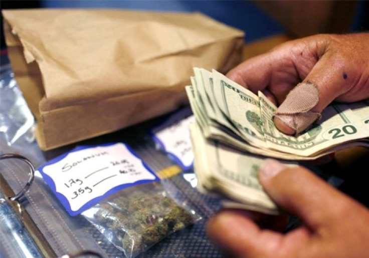 A customer makes a medical marijuana purchase at the Coffeeshop Blue Sky dispensary in Oakland, California June 30, 2010