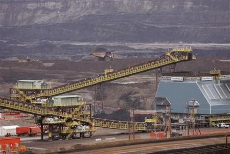 Heavy equipment mines tar sands at Syncrude's Aurora mine in Alberta.