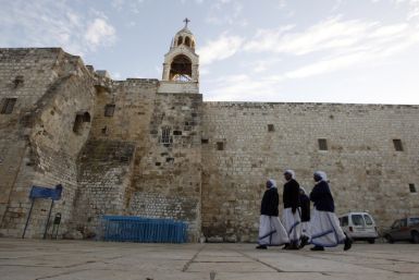 Nuns walk outside the Church of the Nativity in Bethlehem