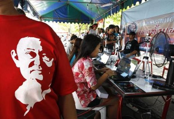 A woman wearing a t-shirt with a picture of former Prime Minister Thaksin Shinawatra