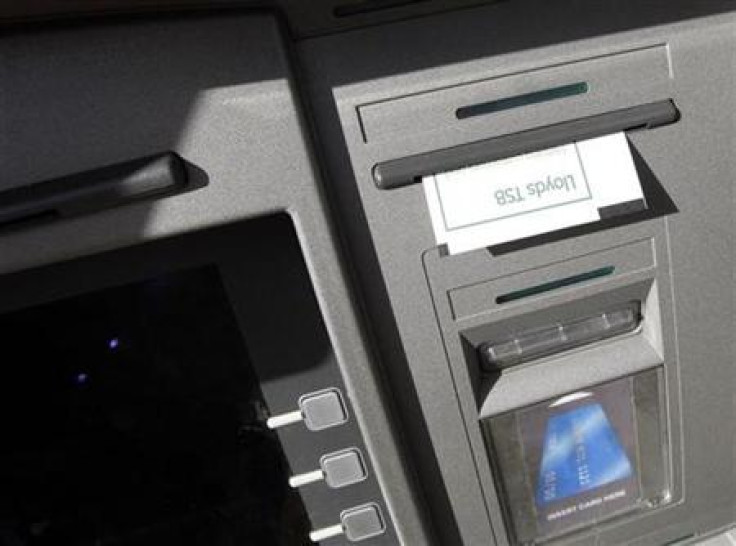 A receipt hangs from a Lloyds TSB Cashpoint machine in Loughborough