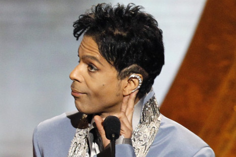 Prince gestures on stage at the 42nd Annual NAACP Image Awards at the Shrine auditorium in Los Angeles March 4, 2011.