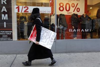 A woman walks past a retail store in the fashion district of New York