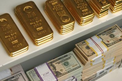 Gold bars and US Dollar bills