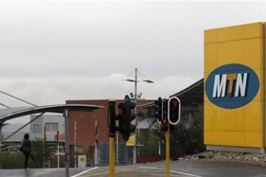A woman walks past the entrance of the headquarters of South Africa's MTN Group