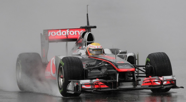 McLaren Formula One driver Hamilton drives in the rain during a training session in Montmelo.