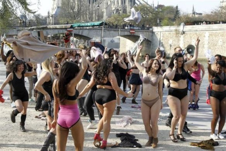 Women in their underwear dance near the Seine river in Paris