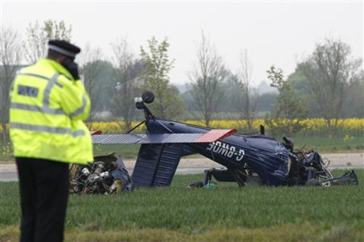 Investigators inspect a light aircraft that crashed with MEP for the UK Independence Party Farage on board at Hinton in the Hedges Airfield in Steane