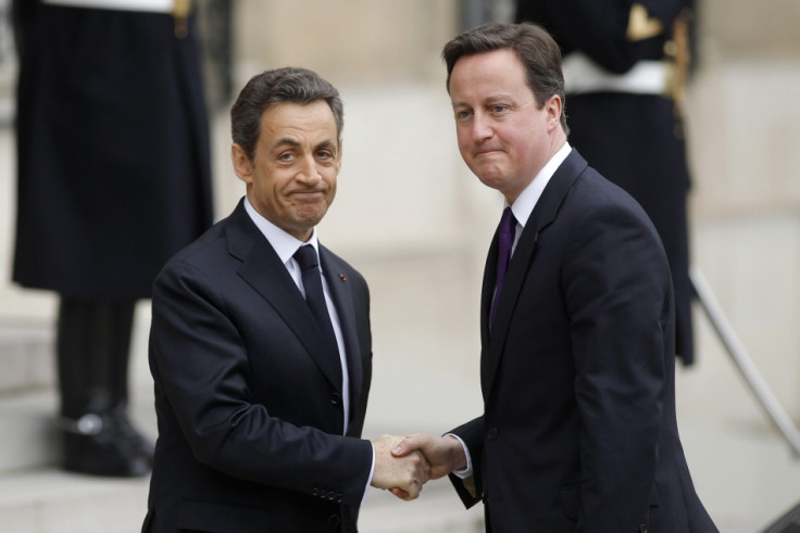 France's President Nicolas Sarkozy (L) greets Britain's Prime Minister David Cameron