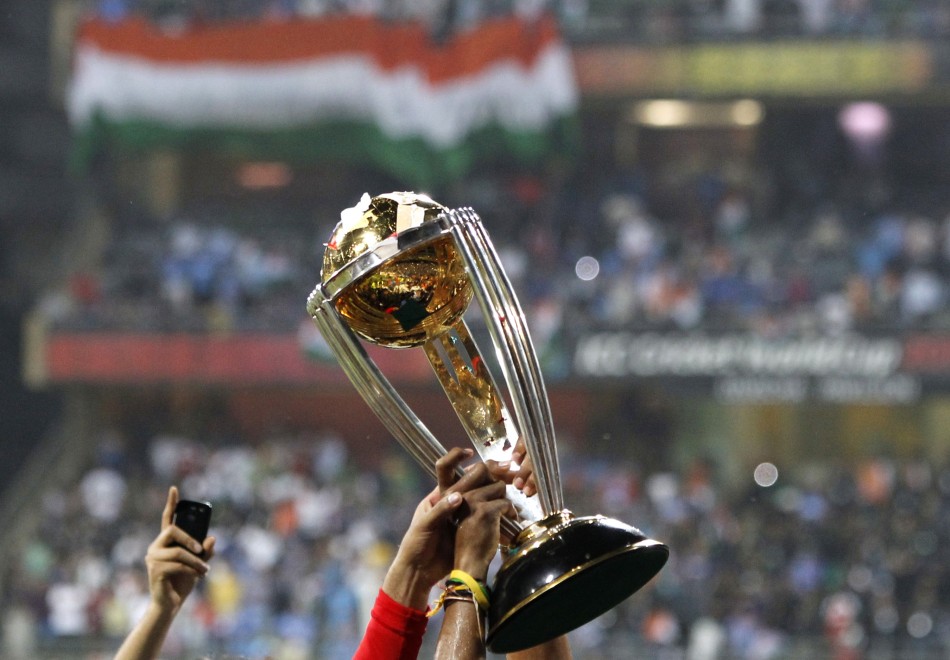 Members of India's squad hold the trophy during celebrations after they defeated Sri Lanka during their ICC Cricket World Cup final match in Mumbai