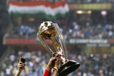 Members of India's squad hold the trophy during celebrations after they defeated Sri Lanka during their ICC Cricket World Cup final match in Mumbai
