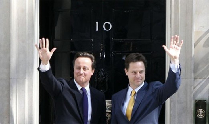 Britain's Prime Minister David Cameron (L) and Deputy Prime Minister Nick Clegg wave on the steps of 10 Downing Street in London May 12, 2010