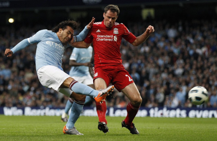 Manchester City's Tevez shoots at goal past Liverpool's Carragher during their English Premier League soccer match at the City of Manchester stadium in Manchester.