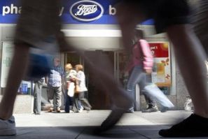 Pedestrians walk past a Boots branch in Leicester, central England