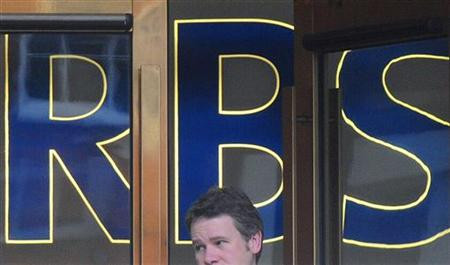 A man leaves a branch of the Royal Bank of Scotland (RBS) in the city of London