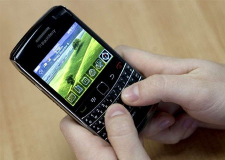 A person poses while using a Blackberry Bold 2 smartphone at the Research in Motion (RIM) headquarters in Waterloo, November 16, 2009