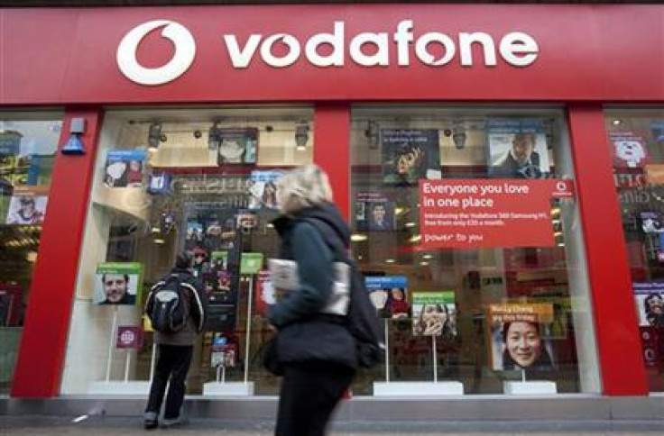 A pedestrian passes a Vodafone store on Oxford Street in central London