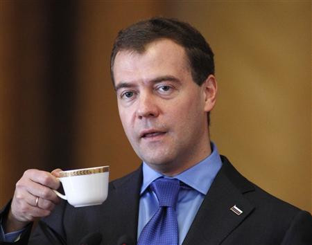 Russia's President Medvedev holds a cup while addressing the audience during his visit to Taras Shevchenko National University in Kiev
