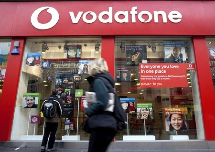 A pedestrian passes a Vodafone store on Oxford Street in central London, November 10, 2009