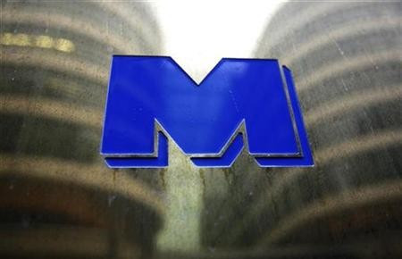 Buildings are reflected in a sign for Man Group hedge fund firm in London