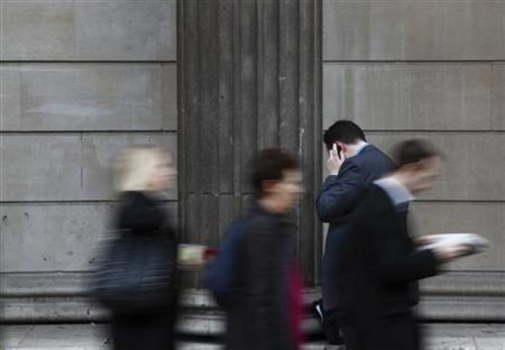 A man uses use mobile phone outside the Bank of England in central London