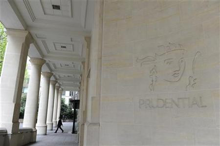 A man leaves the Prudential offices in central London