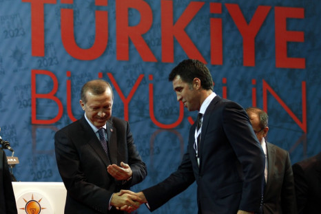 Turkey's PM Erdogan shakes hands with Istanbul candidate Hakan Sukur