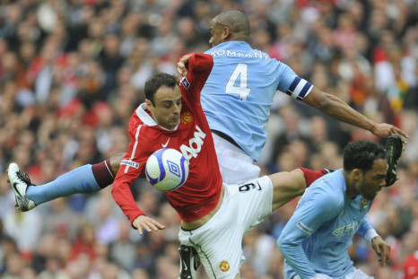 Manchester City's Vincent Kompany and Joleon Lescott challenge Manchester United's Dimitar Berbatov for the ball during their FA Cup semi-final soccer match in London