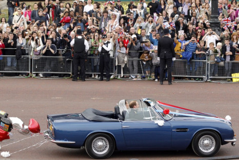 Prince William and his wife Catherine, Duchess of Cambridge drive from Buckingham Palace in an Aston Martin DB6 Mark 2.